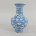 A Chinese blue and white porcelain vase, relief decorated with flowers, character marks to base,