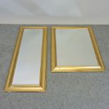 A gilt framed rectangular wall mirror, together with another,