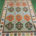 A Turkish woollen carpet, with twelve medallions, on a blue ground,