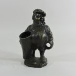 A bronze pen holder, in the form of a golf caddy,