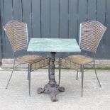 A cast iron garden table with a marble top, 63cm,