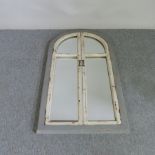 A grey and white painted wooden arched shutter wall mirror,