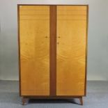 A 1950's Gordon Russell (1892-1980) satinwood and teak double wardrobe,