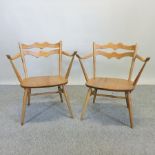 A pair of Ercol light elm cowhorn shaped side chairs