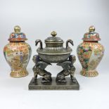 A pair of Chinese ginger jars, together with a decorative centrepiece,