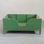A green painted wooden dog's bed,