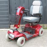 A red Invamed electric mobility scooter,