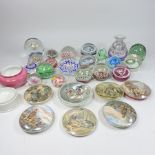 A collection of Prattware pot lids, together with a collection of glass paperweights,