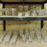 Two shelves of crystal drinking glasses,