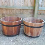 A pair of half barrel planters,
