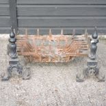 A cast iron fire basket, together with a pair of fire dogs,