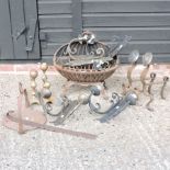 A cast iron fire basket, together with various brass and iron fire dogs and metal wall sconces,