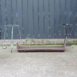 A cast iron pig trough, 125cm, together with a green painted metal plant stand,