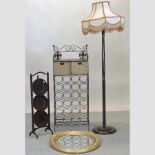An oval gilt framed wall mirror, together with a standard lamp, a cake stand and a wine rack,