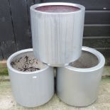 A set of three silver coloured garden pots,