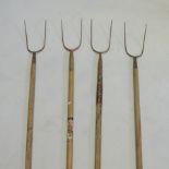 A collection of four vintage pitchforks