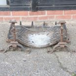 A cast iron fire basket, together with a pair of fire dogs,