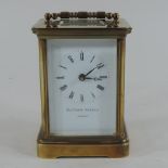 A brass carriage clock, inscribed Matthew Norman,
