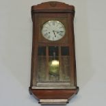A 1920's oak cased wall clock, with a silvered dial,