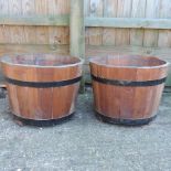 A pair of half barrel planters,
