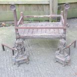 A cast iron fire basket and dogs, together with a smaller pair of fire dogs,