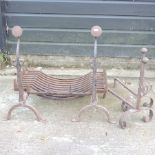 A cast iron fire basket and dogs, together with a pair of smaller fire dogs,