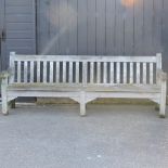 A large teak slatted garden bench,