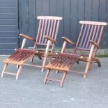 A pair of hardwood reclining garden chairs