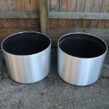 A pair of brushed aluminium effect garden pots,