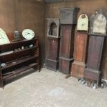 An 18th century longcase clock case, together with three other cases and various movements,
