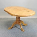 A pine pedestal extending dining table,