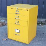 A yellow metal filing cabinet,