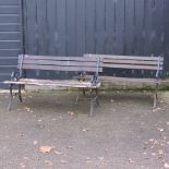 A slatted garden bench with metal ends, together with another,