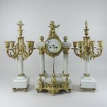 A continental white marble and gilt metal mounted three piece clock garniture, the portico clock,