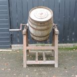 A coopered butter churn on a frame,