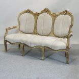A French style gilt framed cream upholstered show frame sofa,