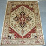 A Heriz style rug, with a central medallion, on a beige ground,