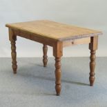 A pine rectangular dining table on turned legs,