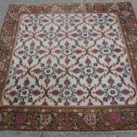 A large Turkish woollen carpet, with all over design, on a cream ground,