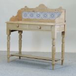 An antique pine washstand, with a tiled back,