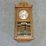 An oak cased wall clock