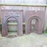 A cast iron fire insert, together with another,