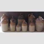 A collection of stoneware advertising jars, highest 41cm,