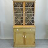An antique pine astragal glazed cabinet bookcase,