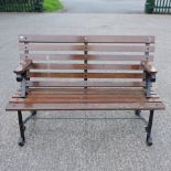 A black painted metal and slatted hardwood garden bench,