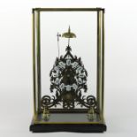 A brass skeleton clock, the enamel dial with Arabic hours, striking on a bell,