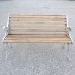 A white painted cast iron and slatted hardwood garden bench,