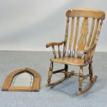 A beech rocking chair, together with a pine framed wall mirror,