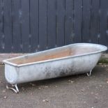 A galvanized metal bath bearing the name Ponda,