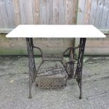 A Singer metal and marble garden table,